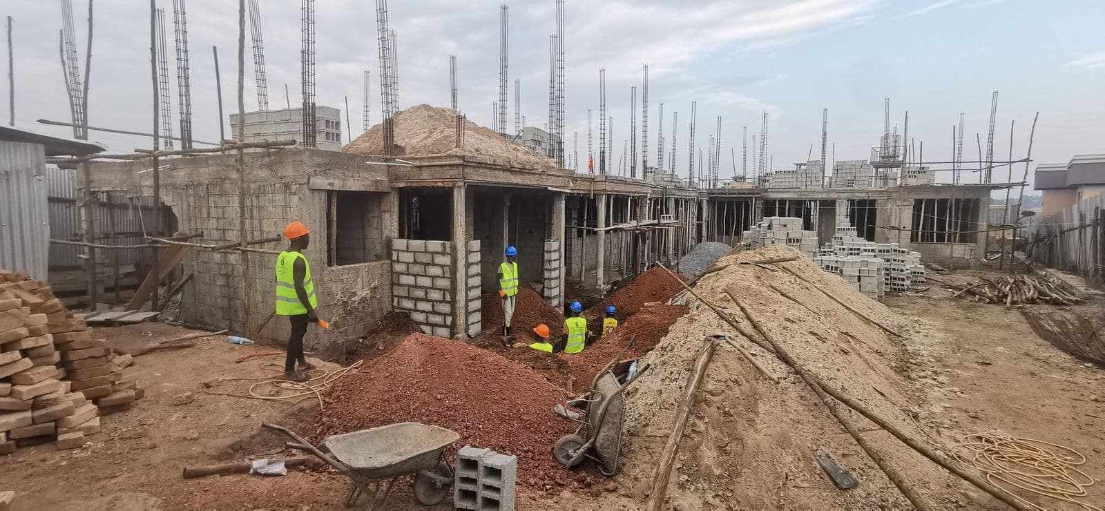 Multi-unit development with workers in safety gear on structural works